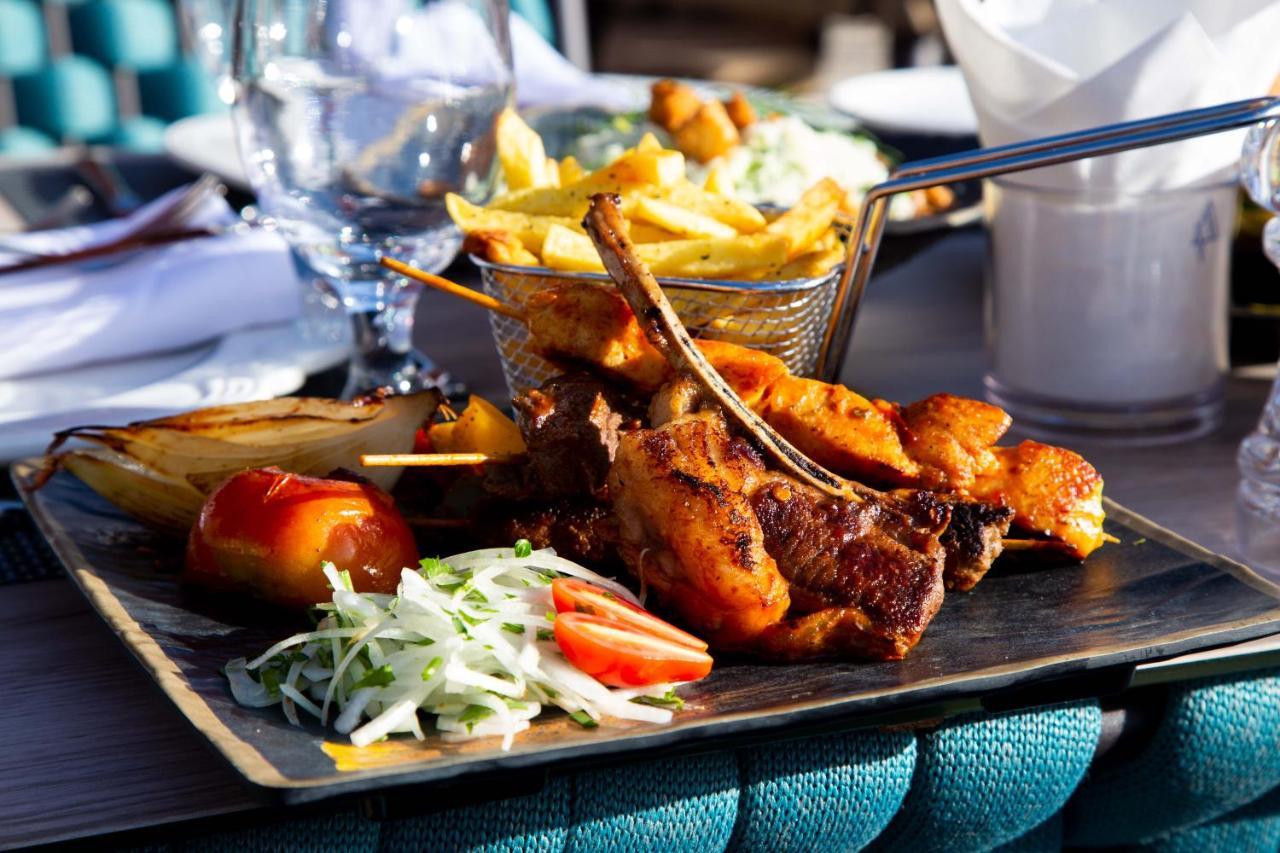 Petra Moon Luxury Hotel Wadi Musa Exterior photo A plate of grilled lamb chops with chips and salad